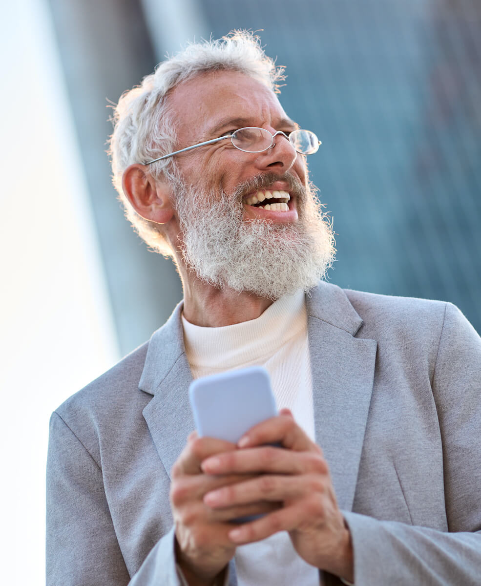 happy-old-professional-business-man-holding-phone-2023-11-27-05-12-40-utc.jpg